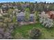 Aerial view of a home showcasing an outdoor deck and spacious green backyard at 7605 E Windlawn Way, Parker, CO 80134