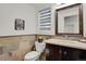 Charming powder room with stone walls, vanity, and decorative fixtures, creating a stylish and inviting space at 7605 E Windlawn Way, Parker, CO 80134
