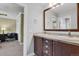 Bathroom featuring a double sink vanity with stone countertop and wood cabinets, offering style and functionality at 7605 E Windlawn Way, Parker, CO 80134