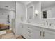 Modern bathroom with double vanity, white cabinets, brushed gold hardware, and walk-in shower at 7605 E Windlawn Way, Parker, CO 80134