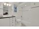 Bright bathroom featuring white subway tile, dark counters, and checkerboard floor at 7605 E Windlawn Way, Parker, CO 80134