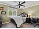 Cozy bedroom with a comfortable bed, ceiling fan, and window view of the lush outdoors at 7605 E Windlawn Way, Parker, CO 80134