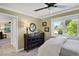 Bedroom with a large window, ceiling fan, and a dresser that complements the natural light and peaceful ambiance at 7605 E Windlawn Way, Parker, CO 80134