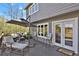 Outdoor living space featuring gray furniture set with dark umbrella and striped chairs at 7605 E Windlawn Way, Parker, CO 80134