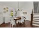 Bright dining room features hardwood floors, chandelier, and access to the deck through glass doors at 7605 E Windlawn Way, Parker, CO 80134