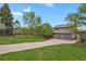 Charming gray two-story home with a two car garage, mature trees, and a large front lawn at 7605 E Windlawn Way, Parker, CO 80134