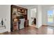 Home office with custom wood desk/shelving looking into a bathroom at 7605 E Windlawn Way, Parker, CO 80134