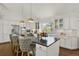 Spacious kitchen features an island, white cabinets, granite counters, stainless appliances, and hardwood floors at 7605 E Windlawn Way, Parker, CO 80134