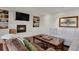 Cozy living room features a brick fireplace, built-in bookshelves and dark hardwood floors at 7605 E Windlawn Way, Parker, CO 80134