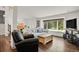 Cozy living room featuring hardwood floors, a large window, and comfortable seating at 7605 E Windlawn Way, Parker, CO 80134
