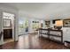 Spacious living room featuring hardwood floors, french doors, a fireplace, and stylish decor, ideal for relaxation at 7605 E Windlawn Way, Parker, CO 80134
