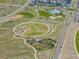 Aerial view of a neighborhood park with playgrounds, athletic fields, and walking paths at 10088 E 62Nd Ave, Denver, CO 80238