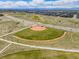 Aerial shot of a baseball field in a community with the cityscape and mountains in the background at 10088 E 62Nd Ave, Denver, CO 80238