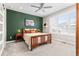 Bedroom with wooden bed frame, side tables, and a large window providing ample natural light at 10088 E 62Nd Ave, Denver, CO 80238