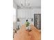 Dining area featuring a wooden table, modern chandelier, and stainless steel refrigerator at 10088 E 62Nd Ave, Denver, CO 80238