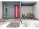 Inviting front porch with modern seating, a bright red door, and contemporary design elements at 10088 E 62Nd Ave, Denver, CO 80238