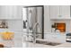 Close-up of a kitchen sink and counter, showcasing modern fixtures, stainless steel appliances and white cabinets at 10088 E 62Nd Ave, Denver, CO 80238