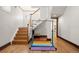 Basement with stairs, hardwood floors, and a rainbow mat at 595 S Race St, Denver, CO 80209