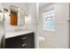 Updated bathroom with a dark vanity, marble countertop, and hexagon tile floor at 595 S Race St, Denver, CO 80209