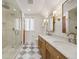 Bathroom with double vanity, marble countertops, and a glass shower at 595 S Race St, Denver, CO 80209