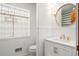 Updated bathroom with white vanity and gold fixtures at 595 S Race St, Denver, CO 80209