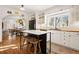 Modern kitchen with white cabinets, marble island, and wood countertops at 595 S Race St, Denver, CO 80209