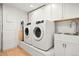 Laundry room with washer, dryer, sink, and built-in cabinets at 595 S Race St, Denver, CO 80209