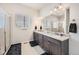 Elegant bathroom with double vanity and large shower at 16122 Emporia Way, Brighton, CO 80602