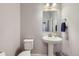 Clean powder room with pedestal sink and updated fixtures at 16122 Emporia Way, Brighton, CO 80602