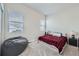 Cozy bedroom with a red and black plaid comforter at 16122 Emporia Way, Brighton, CO 80602