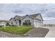 Two-car garage ranch home with gray siding and a landscaped yard at 16122 Emporia Way, Brighton, CO 80602