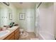 Fresh-looking bathroom with double vanity, shower-tub combo, and bright, inviting decor at 2214 E 101St Ave, Thornton, CO 80229