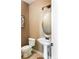 Powder room featuring a pedestal sink, toilet, and stylish decor at 2214 E 101St Ave, Thornton, CO 80229
