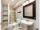 Updated bathroom features tile shower, pedestal sink, and modern fixtures at 2214 E 101St Ave, Thornton, CO 80229