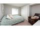 Cozy bedroom with a full-sized bed, chair and large closet at 2214 E 101St Ave, Thornton, CO 80229