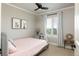 Cozy bedroom with a decorative bed, shuttered window with view, and overhead ceiling fan at 2214 E 101St Ave, Thornton, CO 80229