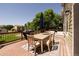 Outdoor deck area with a dining table, chairs, umbrella, and seating, perfect for entertaining at 2214 E 101St Ave, Thornton, CO 80229