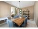 Bright dining room featuring a wooden table, upholstered chairs, and modern light fixture at 2214 E 101St Ave, Thornton, CO 80229