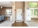 Welcoming entryway featuring wood floors, white trim, ample natural light, and closet space at 2214 E 101St Ave, Thornton, CO 80229
