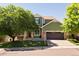 Charming two-story home with green siding, brick accents, well-manicured lawn, and a two-car garage at 2214 E 101St Ave, Thornton, CO 80229