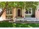 Inviting front porch with decorative flowers, seating, and a well-maintained lawn at 2214 E 101St Ave, Thornton, CO 80229
