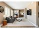 Spacious living room with a fireplace, modern furnishings, and ample natural light at 2214 E 101St Ave, Thornton, CO 80229