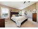 Spacious main bedroom featuring a king bed, ceiling fan, and ample natural light from the shuttered windows at 2214 E 101St Ave, Thornton, CO 80229