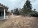 Expansive backyard with a patio area, mature trees, and partial privacy fence at 11306 E Colorado Dr, Aurora, CO 80012