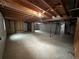 Unfinished basement with exposed ceiling beams and a concrete floor at 11306 E Colorado Dr, Aurora, CO 80012