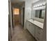 Bathroom featuring neutral vanity, countertop, and tile flooring at 11306 E Colorado Dr, Aurora, CO 80012