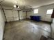Spacious two car garage with white doors, storage space, and blue recycling bins at 11306 E Colorado Dr, Aurora, CO 80012