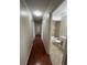 Hallway leading to bathroom with tub and tiled floor at 11306 E Colorado Dr, Aurora, CO 80012