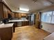 The kitchen features wooden floors, cabinets, stainless steel appliances, and laminate countertops at 11306 E Colorado Dr, Aurora, CO 80012