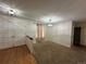 Entryway featuring hardwood floors, with carpeted living room and modern lighting at 11306 E Colorado Dr, Aurora, CO 80012